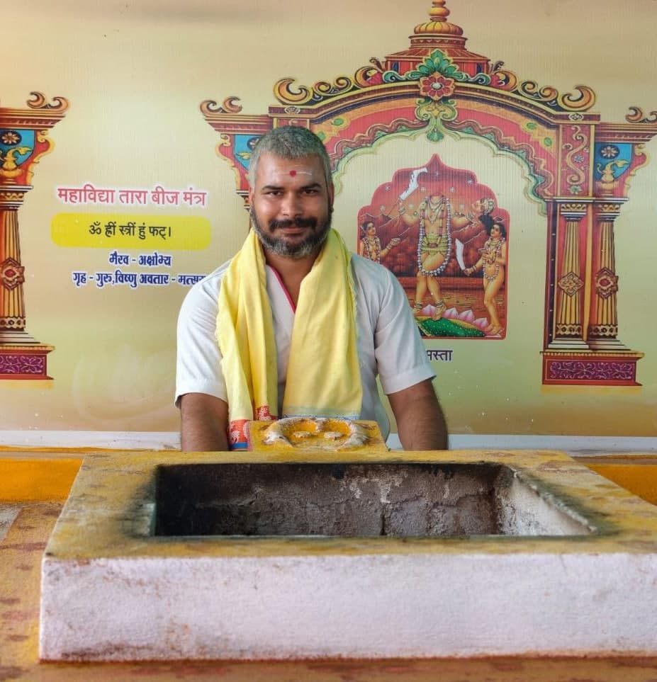 Authentic, dignified documentary portrait of a revered Indian Hindu Pandit Ji in a quiet, sacred temple background